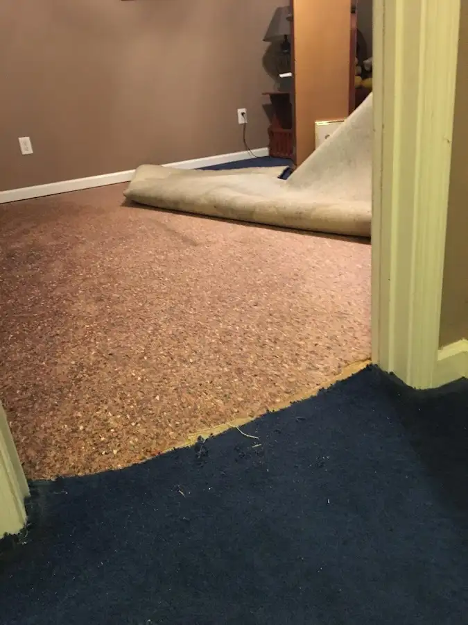 Carpet pad removal revealing water damage during Water Mitigation Services in Vinita